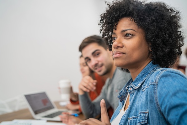 Professional woman listening attentively during a workplace meeting